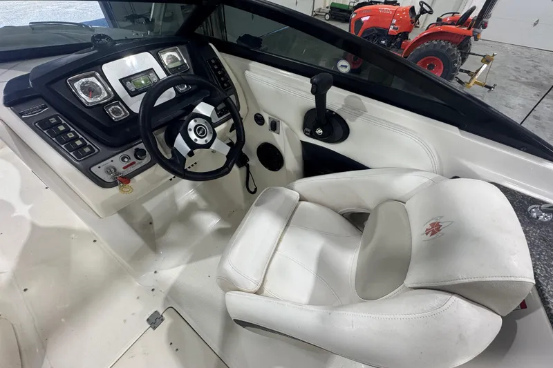 Slide: The Image of 2008 Chaparral Sunesta 244 Xtreme boat cockpit with steering wheel and control panel. - 10