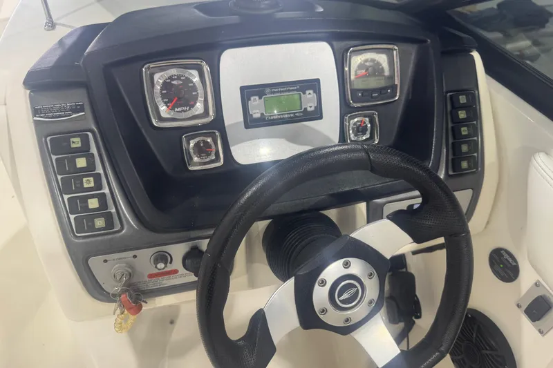 Slide: The Image of 2008 Chaparral Sunesta 244 Xtreme dashboard with steering wheel and control panel. - 11