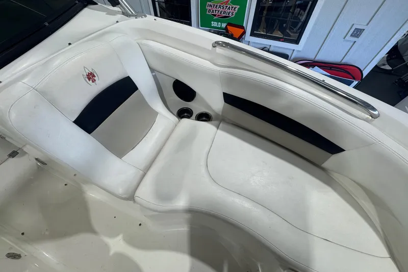 Slide: The Image of 2008 Chaparral Sunesta 244 Xtreme boat interior with white seating and cup holders. - 12