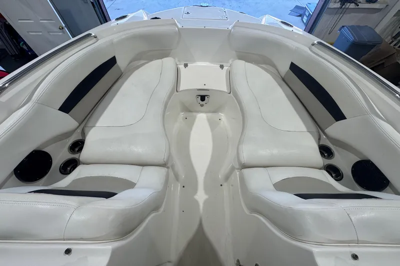 Slide: The Image of 2008 Chaparral Sunesta 244 Xtreme boat interior with white seating and cup holders. - 14