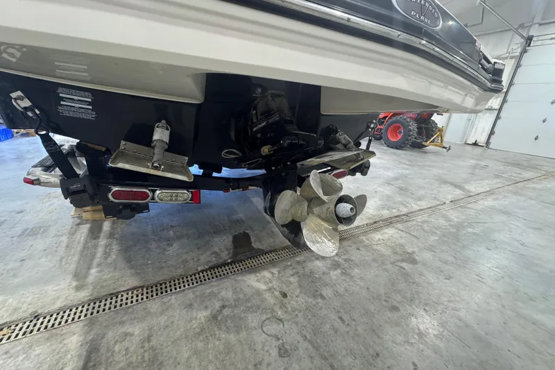 Slide: The Image of 2008 Chaparral Sunesta 244 Xtreme boat in garage, showing propeller and rear details. - 2