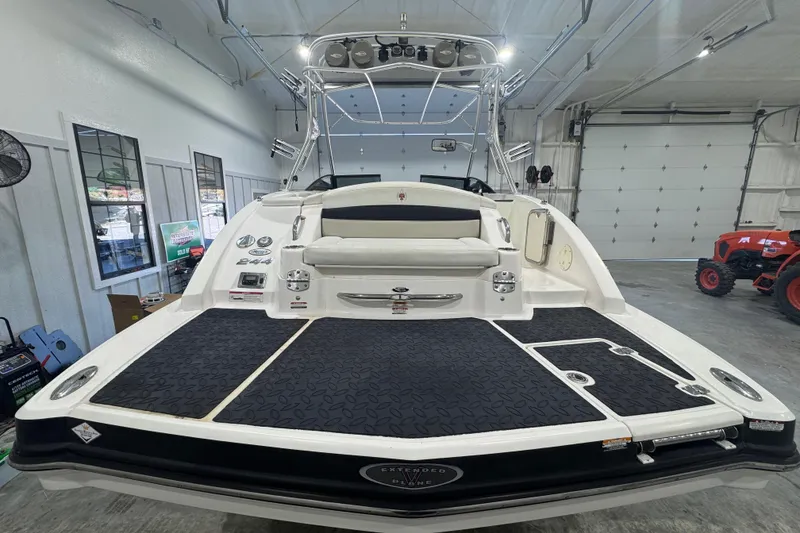 Slide: The Image of 2008 Chaparral Sunesta 244 Xtreme boat in a garage, rear view with swim platform. - 3