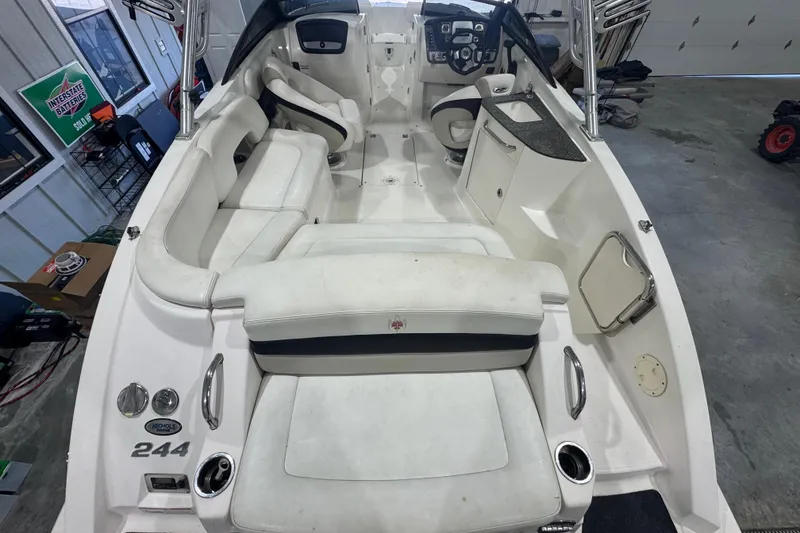 Slide: The Image of 2008 Chaparral Sunesta 244 Xtreme boat interior with white seating and control panel. - 7