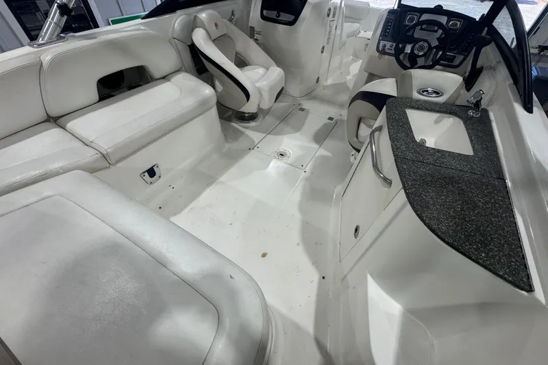 Slide: The Image of 2008 Chaparral Sunesta 244 Xtreme boat interior with seating, steering wheel, and sink. - 8