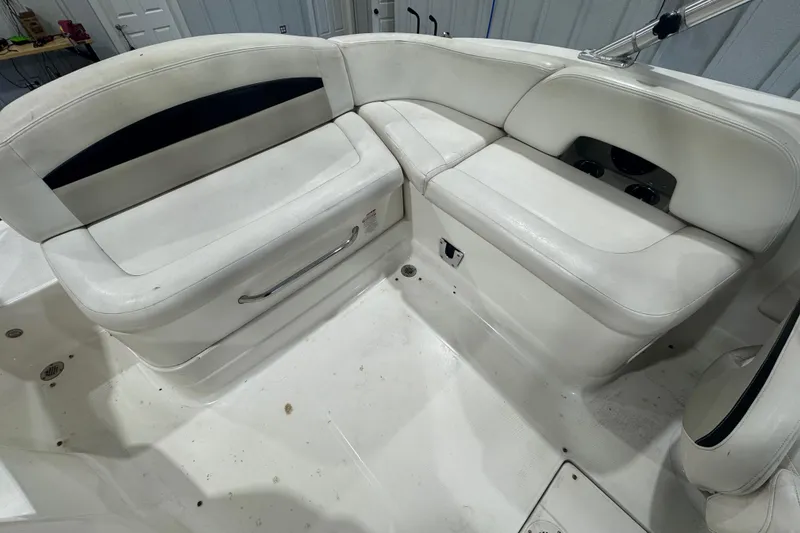 Slide: The Image of 2008 Chaparral Sunesta 244 Xtreme boat interior with white seating and cup holders. - 9