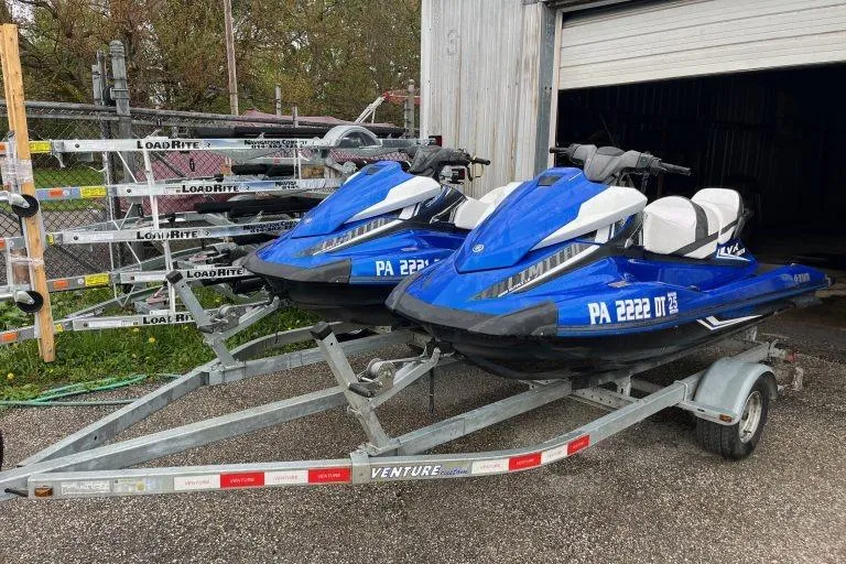 Slide: The Image of 2017 Yamaha WaveRunner VX Limited jet skis on a trailer, parked outdoors. - 2