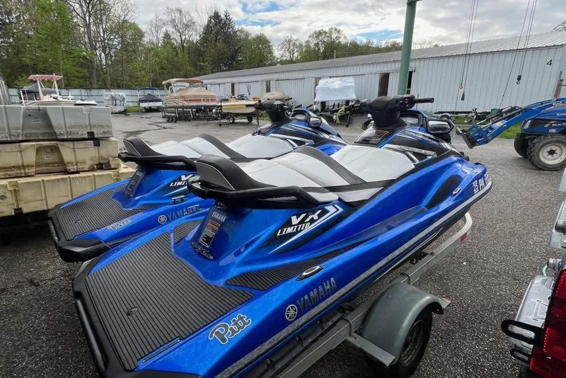 Slide: The Image of 2017 Yamaha WaveRunner VX Limited jet skis on a trailer in a storage area. - 5