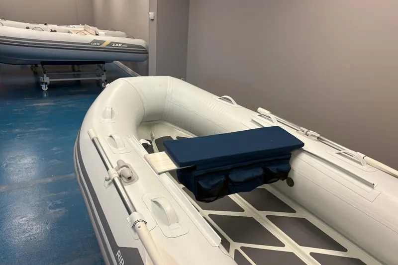 Slide: The Image of 2022 ZAR Mini 10 Lite inflatable boats in showroom, featuring sleek design and durable construction. - 4