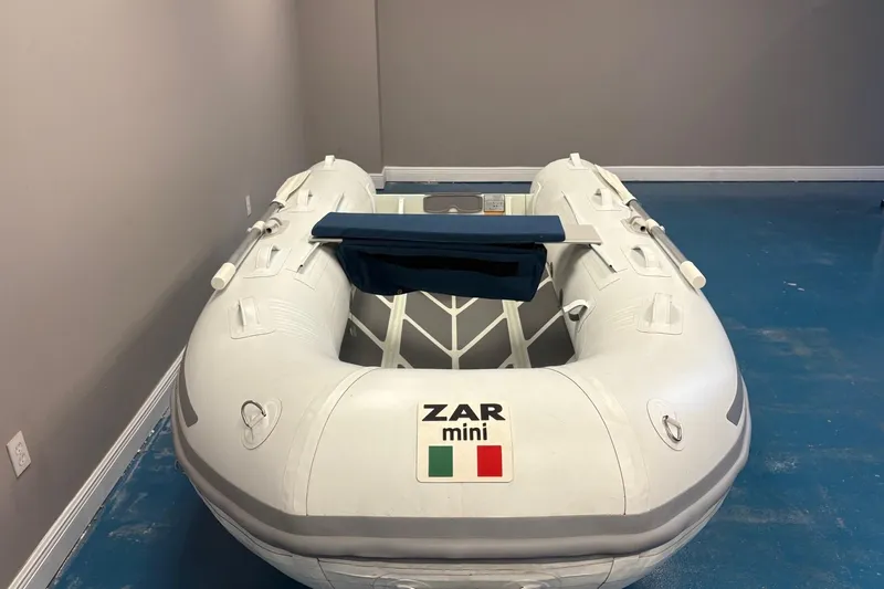 Slide: The Image of 2022 ZAR Mini 10 Lite inflatable boat in a room with blue flooring. - 5