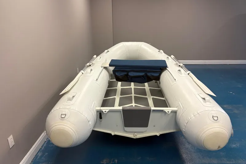 Slide: The Image of 2022 ZAR Mini 10 Lite inflatable boat in a showroom setting. - 6