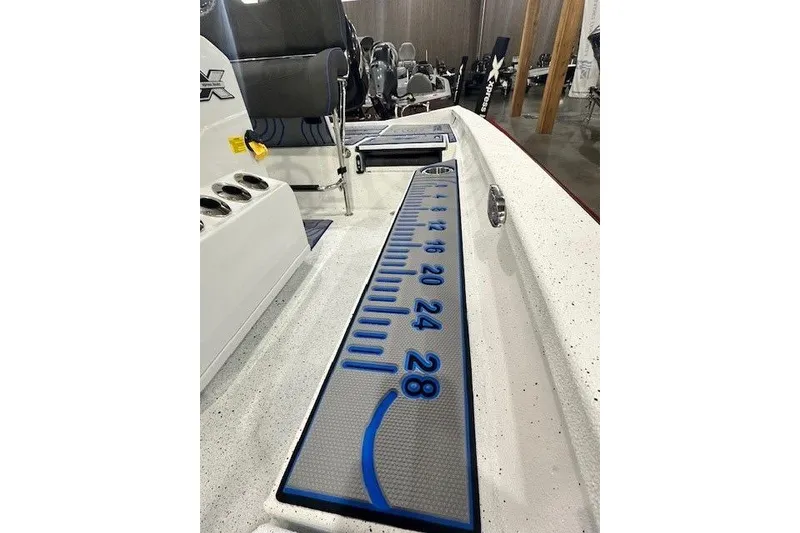 Slide: The Image of 2026 Xpress H20B Bay boat interior with measuring ruler on deck. - 9
