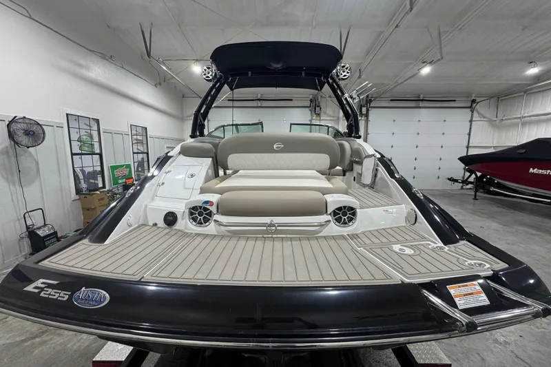Slide: The Image of 2021 Crownline Eclipse E255 SURF boat in indoor showroom, rear view. - 4