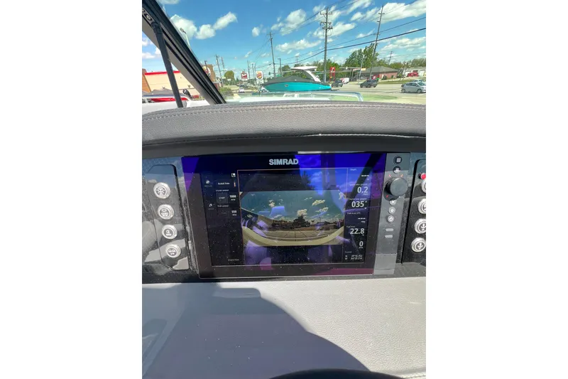 Slide: The Image of 2026 Chaparral SSX 6 dashboard with Simrad display, showing navigation and controls. - 13
