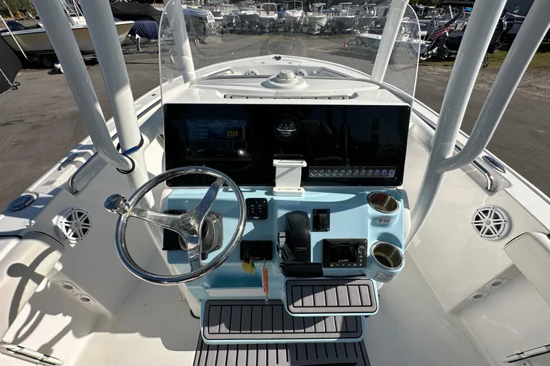 Slide: The Image of 2023 Tidewater 210 CC Adventure boat on trailer under clear blue sky. - 12