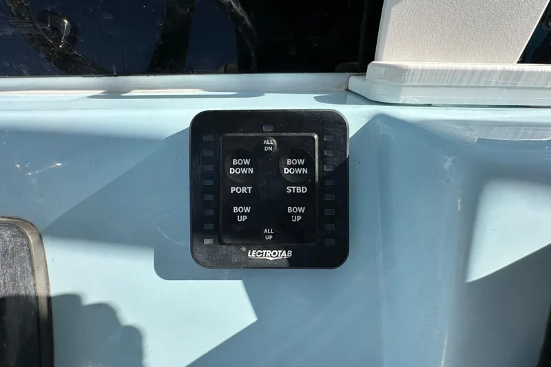 Slide: The Image of 2023 Tidewater 210 CC Adventure boat interior with seating and rod holders. - 14