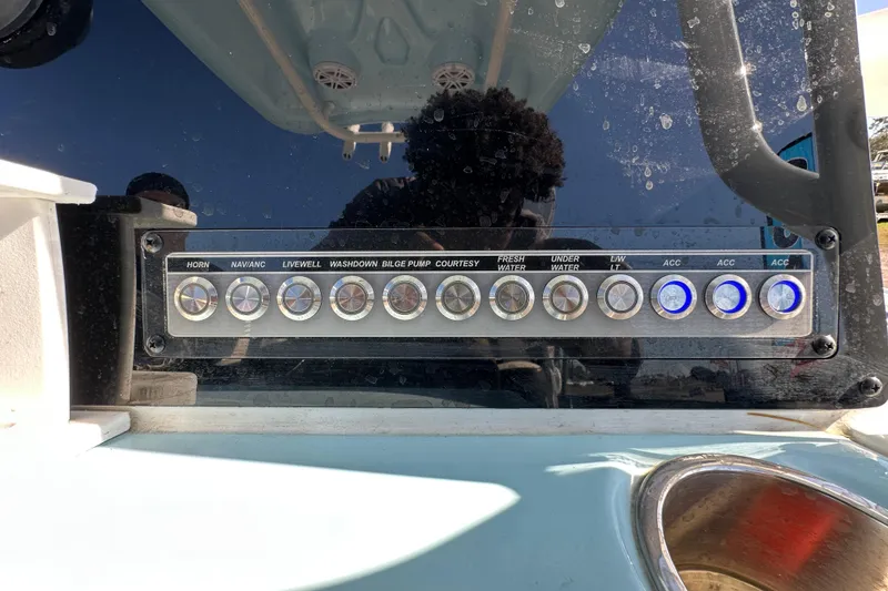 Slide: The Image of 2023 Tidewater 210 CC Adventure boat, spacious deck, clear sky, outdoor display. - 15