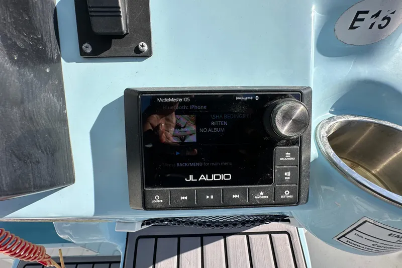 Slide: The Image of 2023 Tidewater 210 CC Adventure boat interior with rod holders and seating. - 16