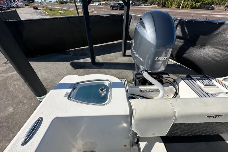 Slide: The Image of 2023 Tidewater 210 CC Adventure boat interior with steering console and seating. - 33