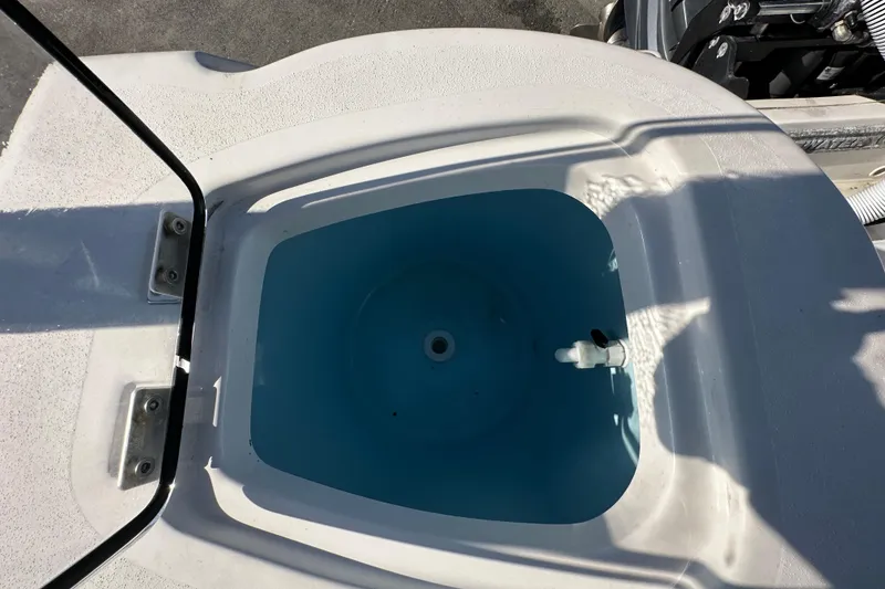 Slide: The Image of 2023 Tidewater 210 CC Adventure boat interior with seating and storage compartment. - 34