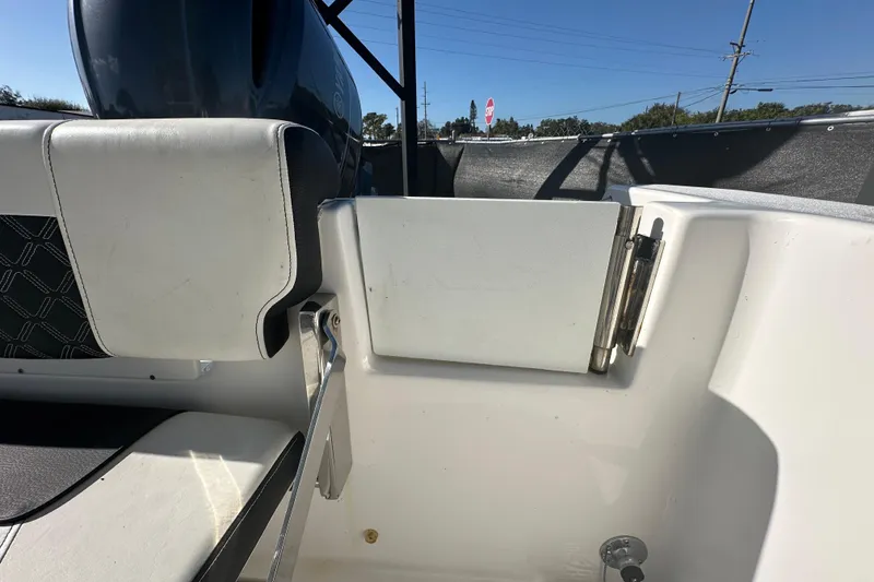 Slide: The Image of 2023 Tidewater 210 CC Adventure boat with open storage compartment and seating. - 35