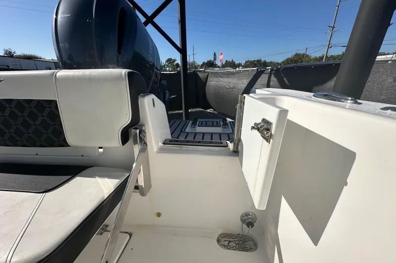 Slide: The Image of 2023 Tidewater 210 CC Adventure interior storage compartment with white walls and floor mat. - 36