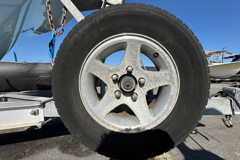 Slide: The Image of 2023 Tidewater 210 CC Adventure boat interior seating and storage compartment. - 42