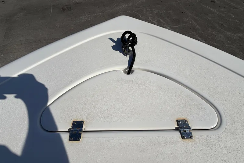 Slide: The Image of Bow storage hatch on 2023 Tidewater 210 CC Adventure boat with rope and hinges. - 48