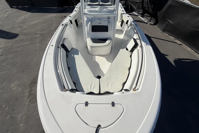 Slide: The Image of 2023 Tidewater 210 CC Adventure boat interior with cushioned seating and console. - 51