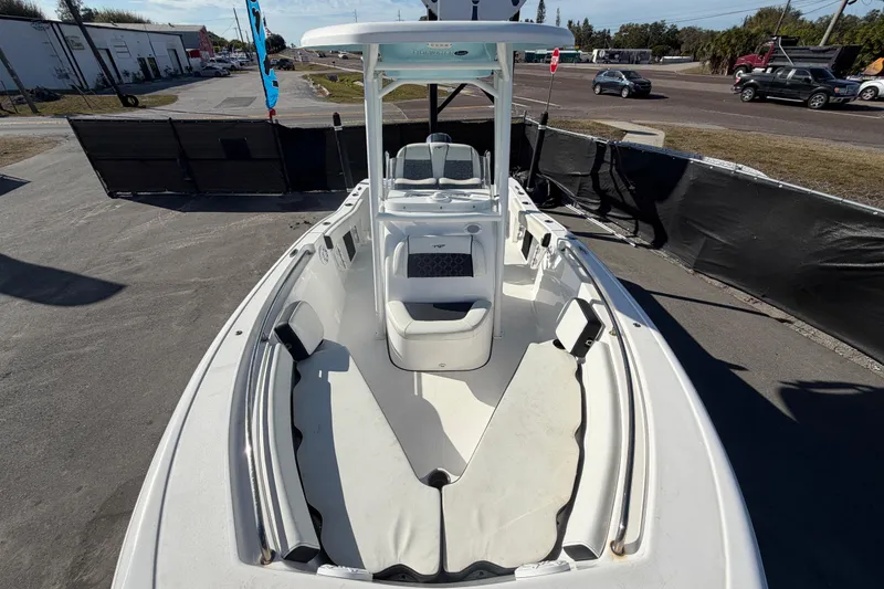 Slide: The Image of 2023 Tidewater 210 CC Adventure boat, white interior, parked outdoors. - 52