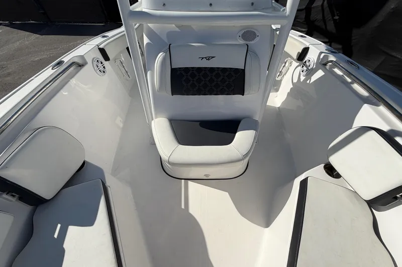 Slide: The Image of 2023 Tidewater 210 CC Adventure boat interior with cushioned seating and speakers. - 53