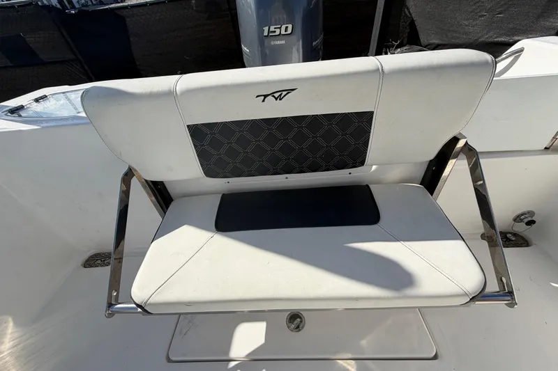 Slide: The Image of 2023 Tidewater 210 CC Adventure boat seat with Yamaha 150 engine in background. - 59
