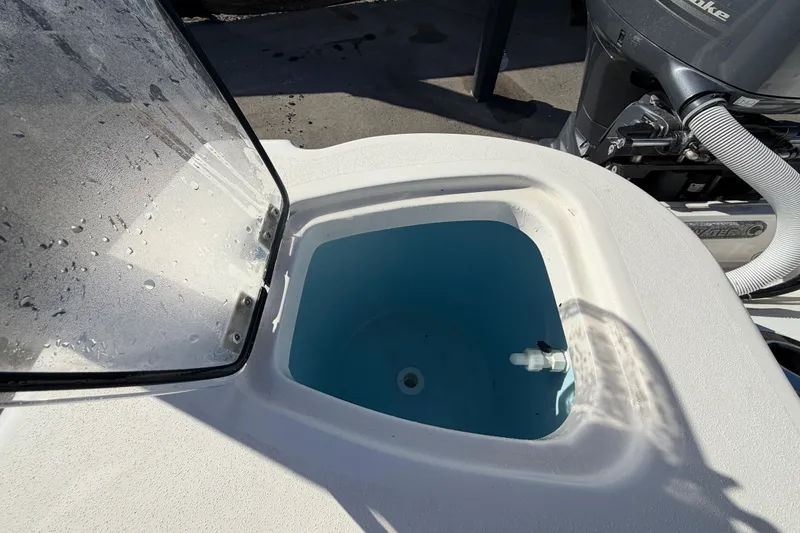Slide: The Image of Livewell on 2023 Tidewater 210 CC Adventure boat, featuring a clear lid and blue interior. - 61