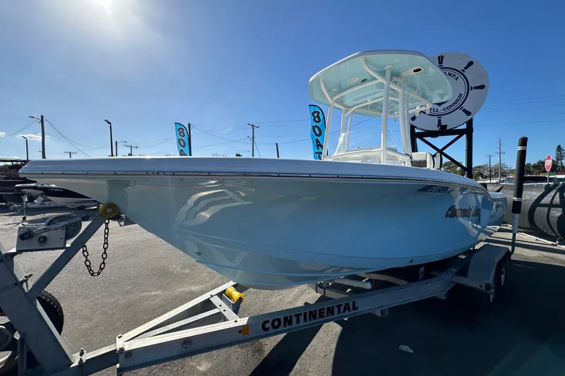 Slide: The Image of 2023 Tidewater 210 CC Adventure boat with Yamaha outboard motor, parked outdoors. - 7