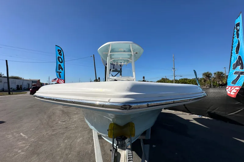 Slide: The Image of 2023 Tidewater 210 CC Adventure boat with Yamaha engine on trailer under blue sky. - 8
