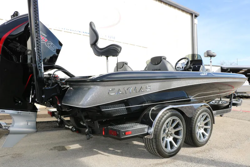 Slide: The Image of 2025 Caymas CX 21 PRO boat with dual-axle trailer, parked outdoors. - 2