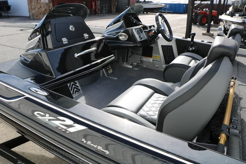Slide: The Image of 2025 Caymas CX 21 PRO boat interior with sleek seating and modern dashboard design. - 21