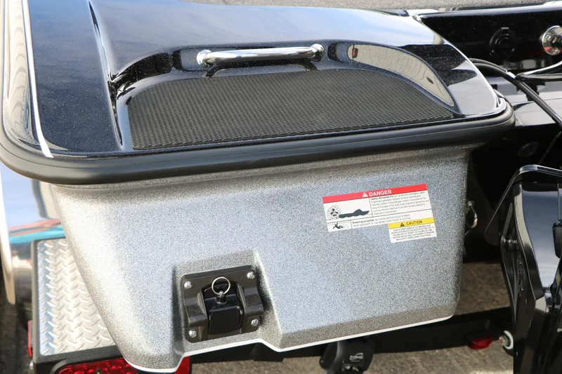 Slide: The Image of 2025 Caymas CX 21 PRO boat rear compartment with safety warning label. - 23