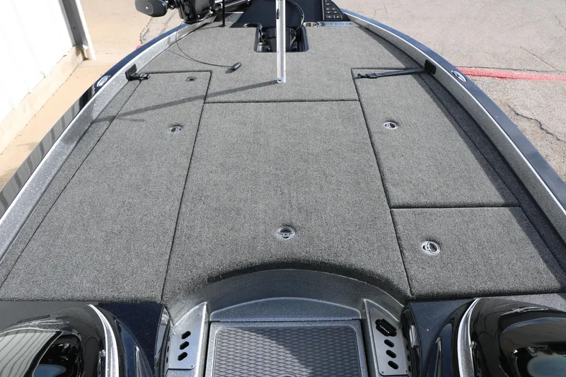 Slide: The Image of 2025 Caymas CX 21 PRO boat deck with gray carpet and storage compartments. - 26