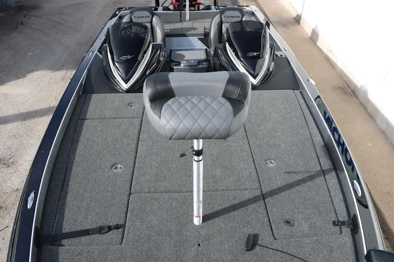 Slide: The Image of 2025 Caymas CX 21 PRO boat interior with dual seats and gray carpeted deck. - 30