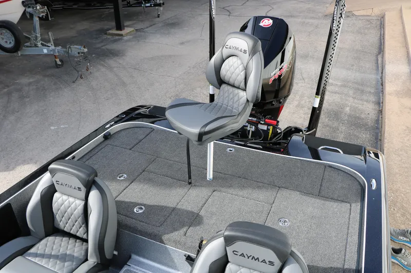 Slide: The Image of 2025 Caymas CX 21 PRO boat interior with cushioned seats and motor. - 35