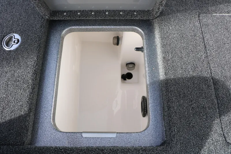 Slide: The Image of 2025 Caymas CX 21 PRO boat storage compartment with textured interior. - 37