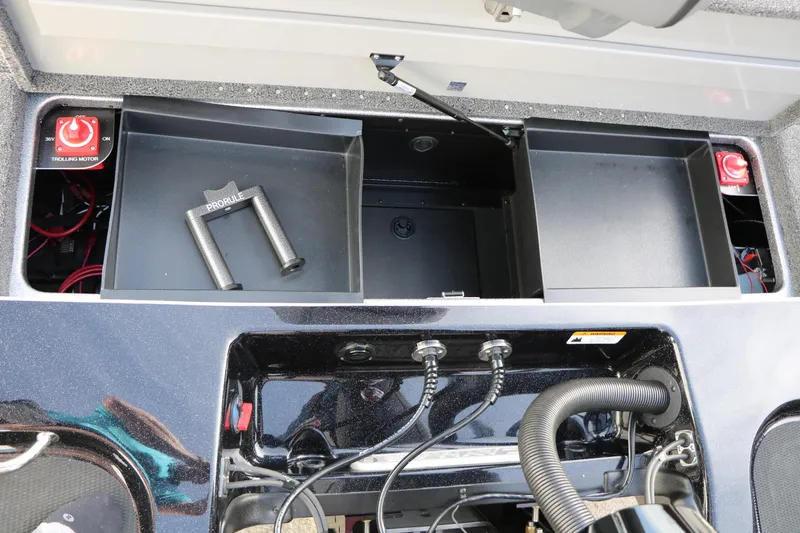 Slide: The Image of 2025 Caymas CX 21 PRO boat storage compartments with trolling motor switches and accessories. - 38