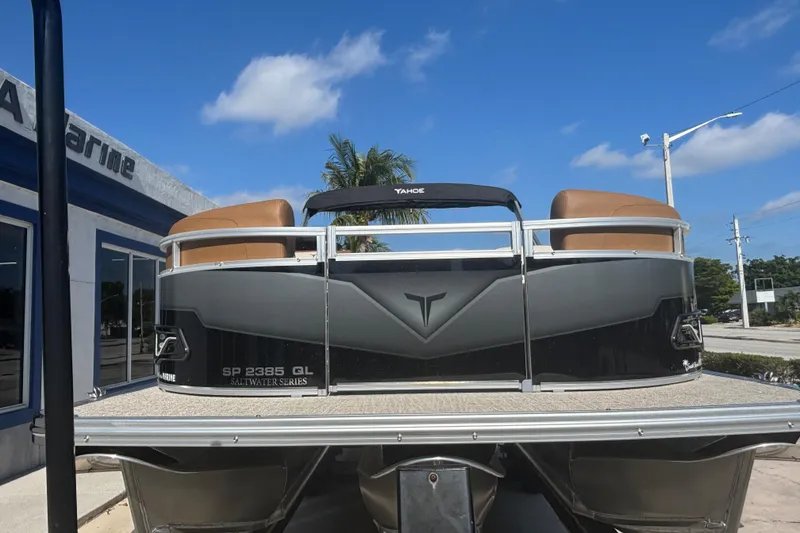 Slide: The Image of 2026 Tahoe Pontoon Sport 85 Quad Lounge, Saltwater Series, displayed outdoors under blue sky. - 5