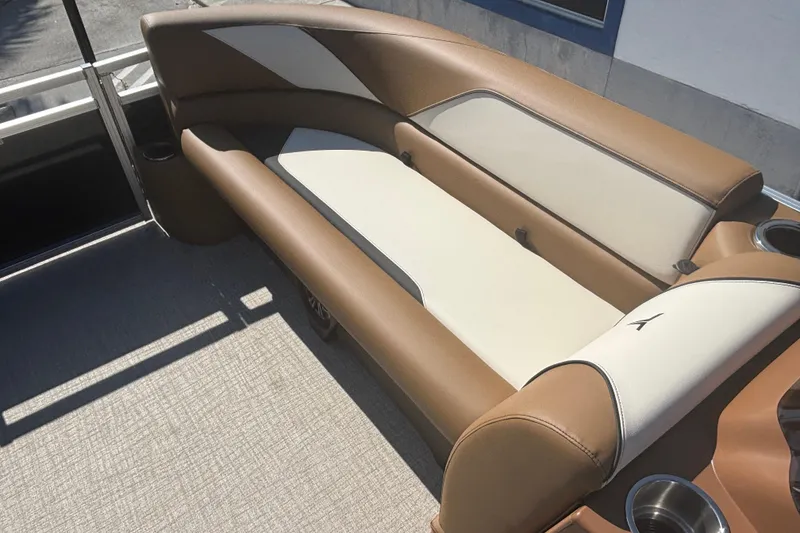 Slide: The Image of 2026 Tahoe Pontoon Sport 85 Quad Lounge with tan and cream seating, cup holders visible. - 7