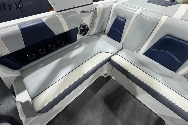 Slide: The Image of 2019 Malibu Wakesetter 21 MLX interior seating with blue and white upholstery. - 10