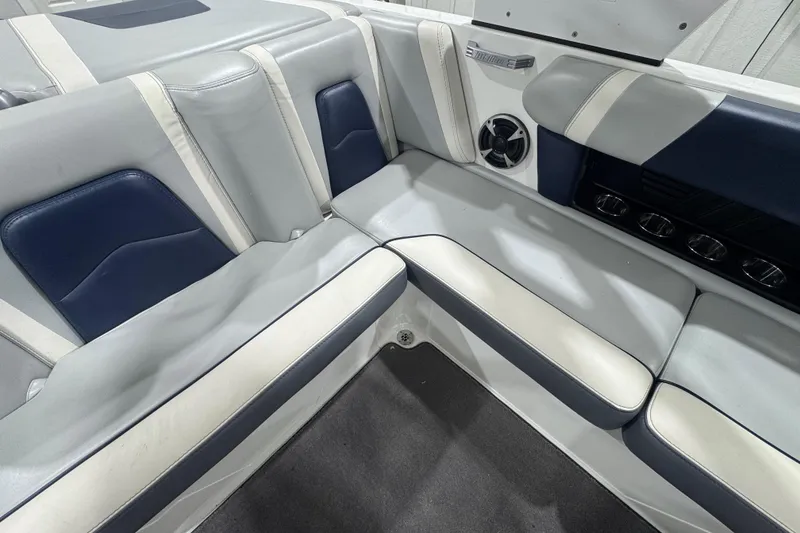 Slide: The Image of 2019 Malibu Wakesetter 21 MLX interior seating with blue and white upholstery. - 11