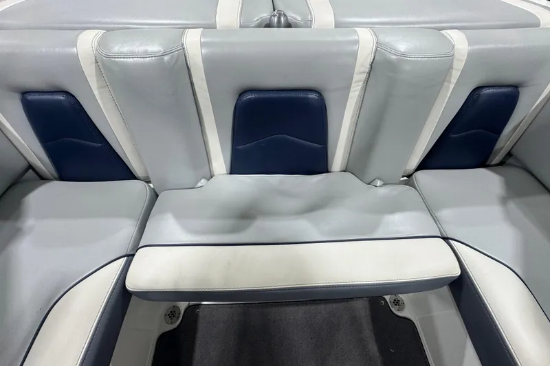 Slide: The Image of 2019 Malibu Wakesetter 21 MLX interior seating, featuring gray and blue upholstery. - 12