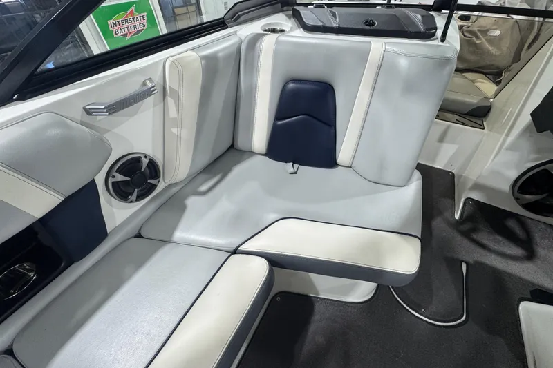 Slide: The Image of 2019 Malibu Wakesetter 21 MLX interior seating with speaker and stylish upholstery. - 13