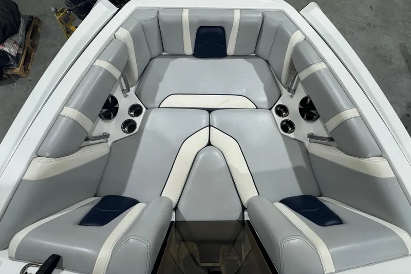 Slide: The Image of 2019 Malibu Wakesetter 21 MLX boat interior with gray and white seating. - 21