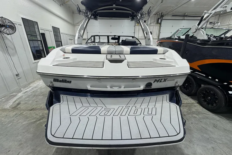 Slide: The Image of 2019 Malibu Wakesetter 21 MLX boat in showroom, rear view with swim platform. - 4